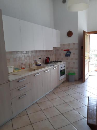 a kitchen with white appliances and a tile floor at Il Pesco - CIR 0024 in Nus