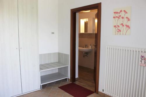 a bathroom with a sink and a toilet and a mirror at Verdemare in Acquaviva Picena