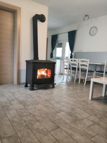 a fireplace in a living room with a stove at Holiday Home Rojko in Štrigova