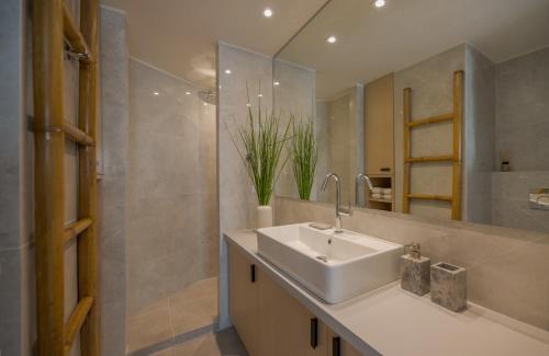 a bathroom with a sink and a mirror at Azur by Stylish Stays in Athens