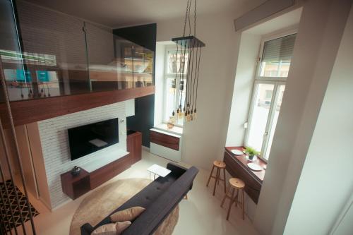 a living room with a couch and a fireplace at Zeus Design Loft Apartments in Vienna