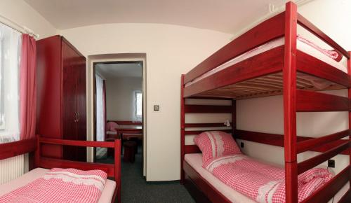 two bunk beds in a room with a desk at Ubytování Karolinka in Prášily
