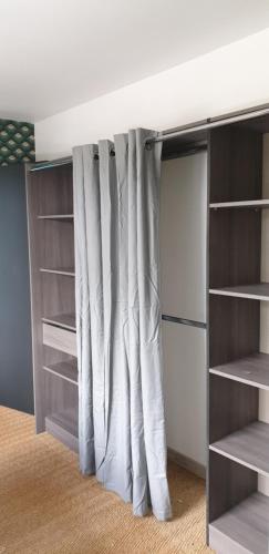 a closet with a curtain in a room at Home sweet home Cabourg plage in Cabourg