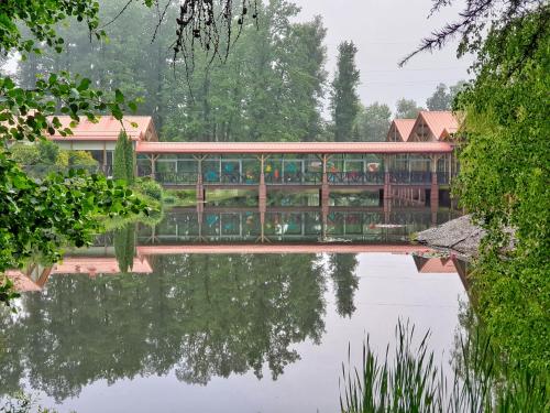 a building with a bridge over a body of water at Stacja Nowa Gdynia Bed & Breakfast Aquapark in Łódź