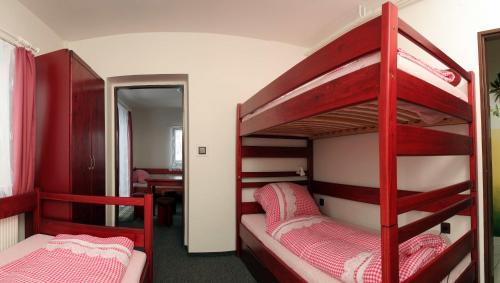 two bunk beds in a room with a desk at Ubytování Karolinka in Prášily