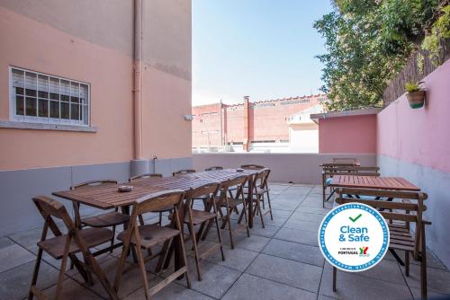 a long wooden table and chairs next to a building at Liverpool Terrace in Lisbon