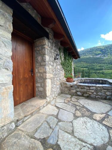 a stone house with a wooden door and a stone patio at Casa Sansón in Chía