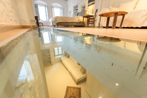 a room with a large pool of water on the floor at Vita Real Estate in Hydra