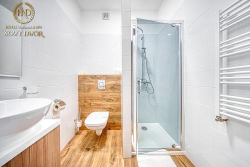 a bathroom with a sink and a toilet and a shower at Hotel Wellness & Spa Nowy Dwór in Rzeszów
