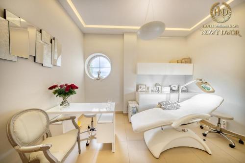 a dental office with a table and chairs in a room at Hotel Wellness & Spa Nowy Dwór in Rzeszów