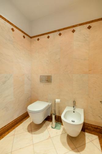 a bathroom with a toilet and a bidet at Lake Front Luxury Apartment in Sirmione