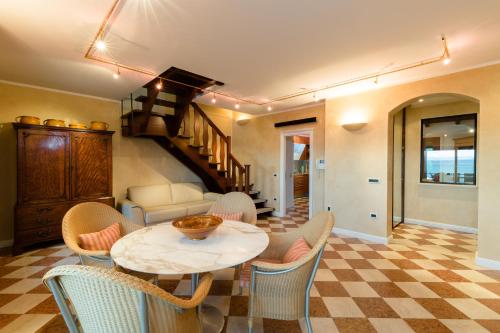 a living room with a table and chairs at Lake Front Luxury Apartment in Sirmione