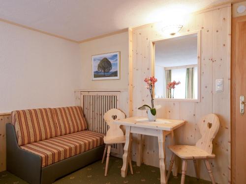 a living room with a couch and a table at Sagritzerwirt in Großkirchheim