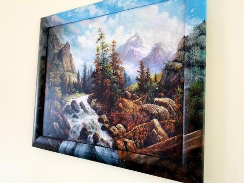 a painting of a waterfall in the mountains at Садиба Святослав in Skhidnitsa