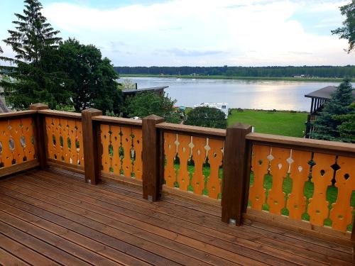 a wooden deck with a view of a lake at Guest House and camping Jurmala in Jūrmala