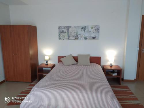a bedroom with a large bed with two night stands at Casa Mosteiro in Braga