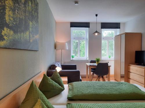 a bedroom with a bed and a living room at Apartments und Bistro Zum Glasmacher in Gehlberg