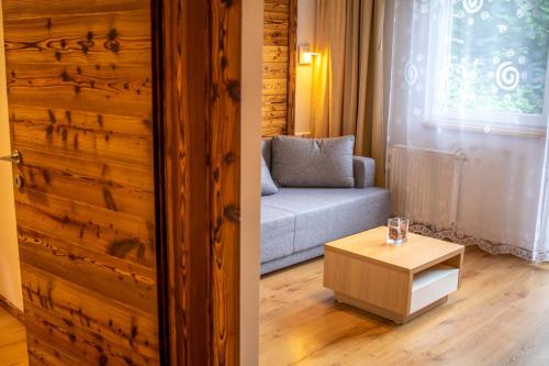 a living room with a couch and a table at Apartment Michael - Zell am See - Kaprun in Piesendorf