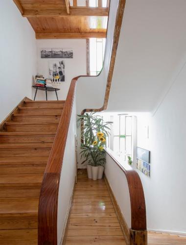 a staircase in a house with wooden floors at Je T'aime Porto Sweet Rooms in Vila Nova de Gaia