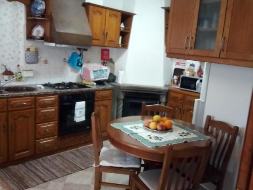 a kitchen with a table with a bowl of fruit on it at Governo's House in Melo