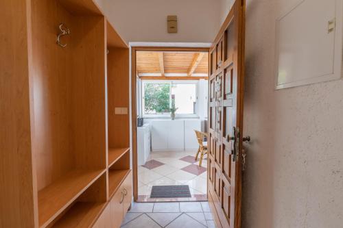 a hallway with a door open to a room at Apartman Lana in Baška