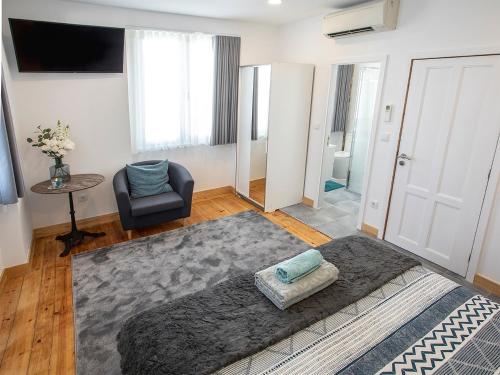 a living room with a couch and a chair at Je T'aime Porto Sweet Rooms in Vila Nova de Gaia