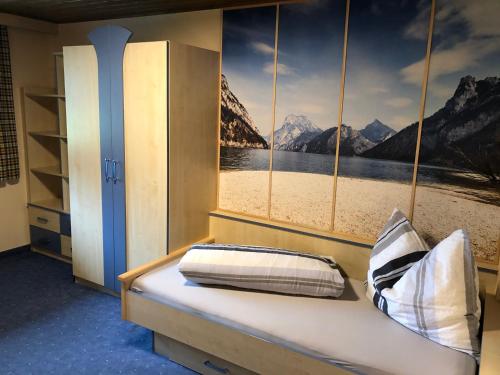 a bedroom with a window with a view of a beach at Ferienhaus Bergfrieden in Sankt Leonhard im Pitztal