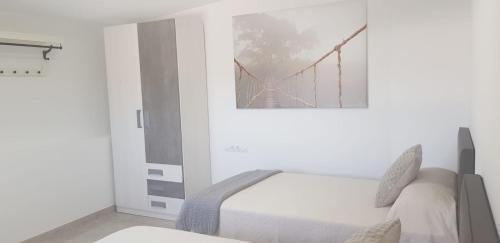 a bedroom with a bed with a picture of a bridge at CASA MIRAMAR FRONTERA in Frontera