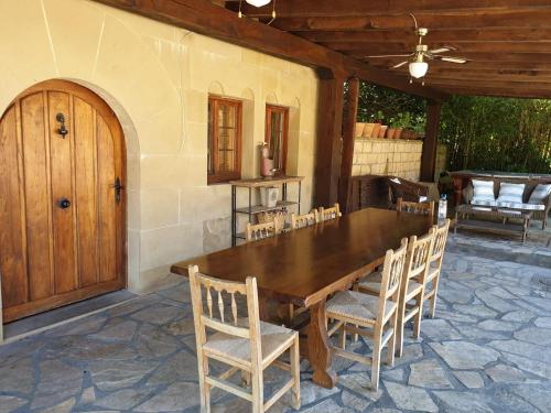 a wooden table and chairs on a patio at Caserio Kamirune in Laukiz