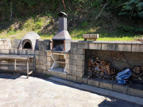 a stone fireplace with a bench and a table at Caserio Kamirune in Laukiz