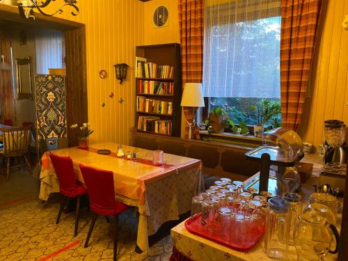 a kitchen with a table and chairs and a window at Pension Waldblick in Spiegelau