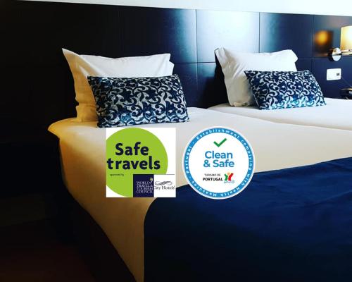 a pair of beds with a sale travels sticker on them at Lisbon City Hotel by City Hotels in Lisbon