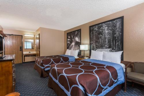 a hotel room with two beds and a flat screen tv at Super 8 by Wyndham Arcata in Arcata