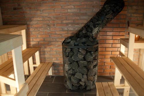 a brick wall with a fireplace in a room at Kaluri puhkemaja in Pärna