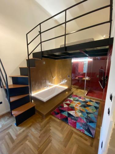 a loft bed with a mosaic floor in a room at Il cortile di Elen in Marsala