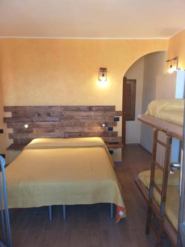 a bedroom with two beds and a wall at La Corte di Nonno Gino in Stresa