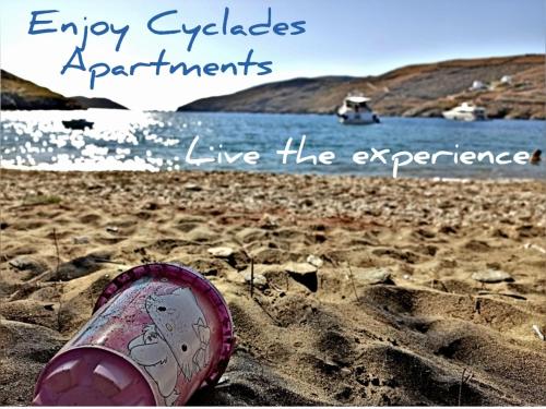 a shoe sitting in the sand on a beach at Enjoy Cyclades studios & suites in Kithnos