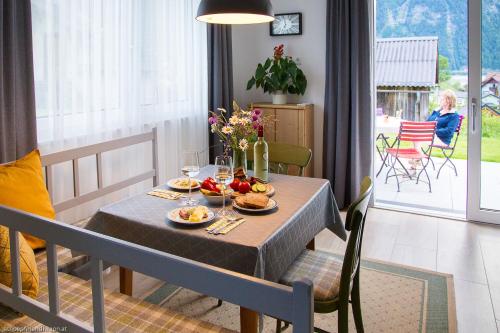 a table with food on it in a living room at Apartment Brigitte in Obertraun
