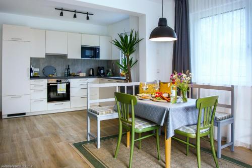 a kitchen and dining room with a table and chairs at Apartment Brigitte in Obertraun