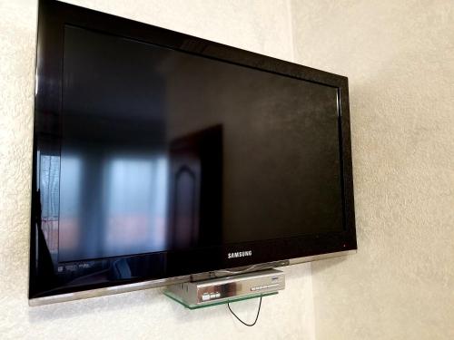 a flat screen tv hanging on a wall at Садиба Святослав in Skhidnitsa