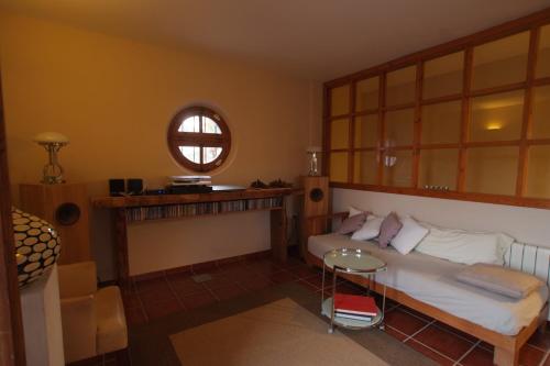 a bedroom with a bed and a table and a window at Casa el Arenal in Níjar