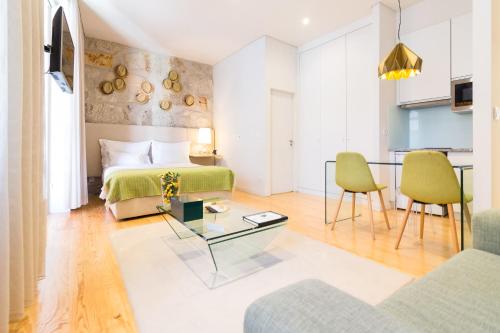 a living room with a bed and a table at Oporto Near Apartments in Porto