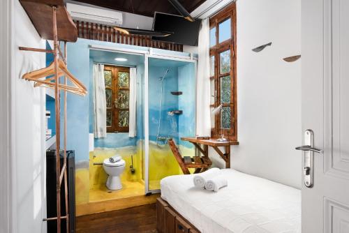 a bedroom with a bathroom with a shower and a toilet at Favela Living Space in Chania