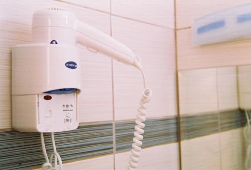 a white hair dryer hanging on a wall at VILLA HARIKLIA in Paralia Katerinis
