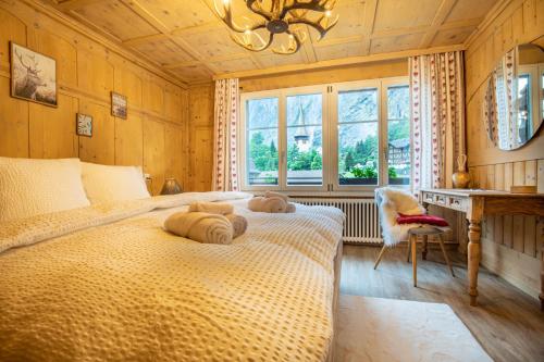 a bedroom with a bed with two pillows on it at Wasserfallhüsli in Lauterbrunnen, near Interlaken, Mürren, Wengen in Lauterbrunnen