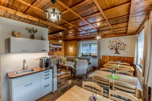 a kitchen and dining room with a table and chairs at Ubytovanie Žember in Demanovska Dolina