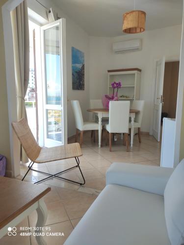 a living room with a table and chairs at 100 passi dal mare in Agropoli