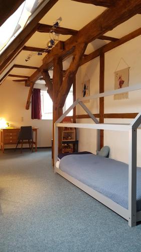 a bedroom with a bunk bed in a attic at Apartment Altes Pfarrhaus in Plau am See in Plau am See