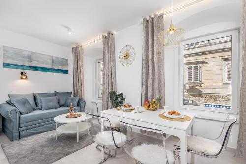 a living room with a couch and a table at Srnec Apartments - Korzo in Rijeka