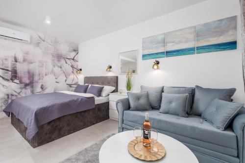 a living room with a bed and a couch at Srnec Apartments - Korzo in Rijeka